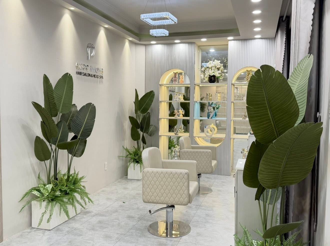 Styling chairs and greenery inside Quoc Phong Hair Salon